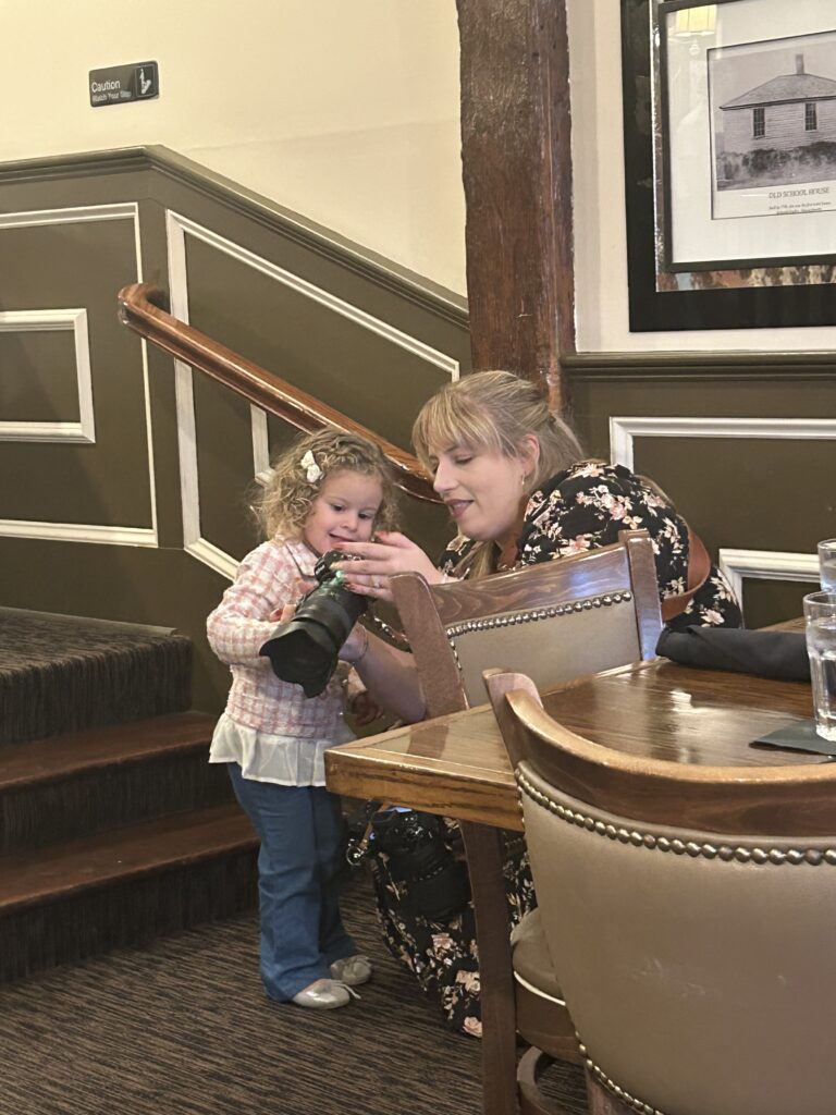 Photographer showing child a photo