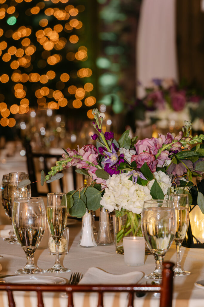 Winter wedding reception table details with florals and candlelight at Birch Wood Vineyards in Derry New Hampshire