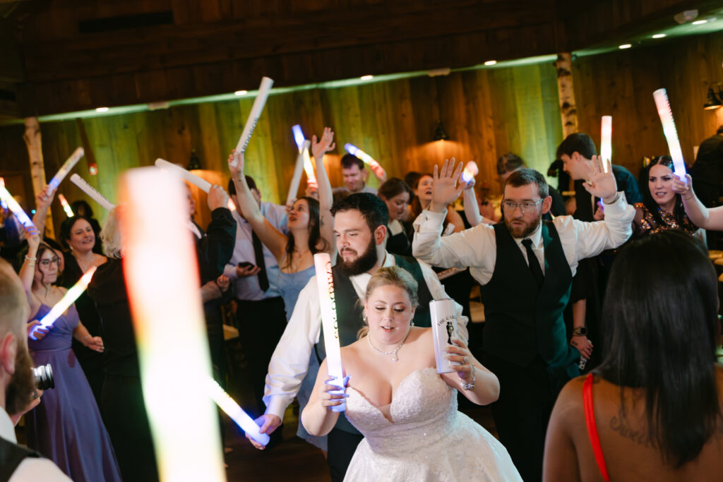 Bride and groom celebrating on the dance floor during winter wedding reception at Birch Wood Vineyards in Derry New Hampshire