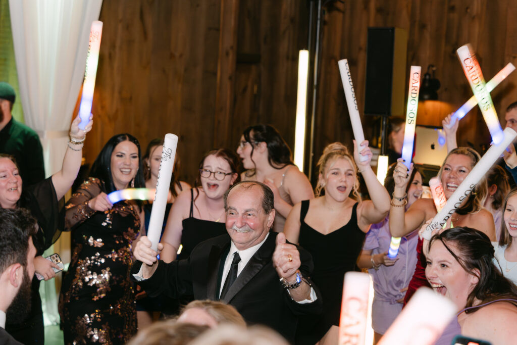 Issac’s grandfather celebrating on the dance floor during winter wedding reception at Birch Wood Vineyards in Derry New Hampshire