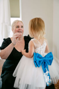 Massachusetts Wedding Planner helps flower girl get ready before backyard wedding