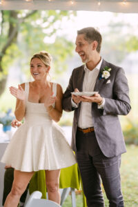  Romantic backyard wedding reception with bride and groom celebrating outdoors planned by Massachusetts wedding planner and photographed by Massachusetts wedding photographer