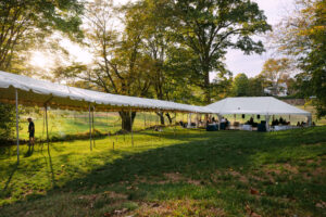  Outdoor tent wedding reception setup in scenic New England back yard Massachusetts wedding planner and photographed by Massachusetts wedding photographer