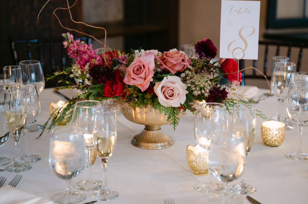 a romantic table scape and centerpiece with pink and red roses at Willowdale estate